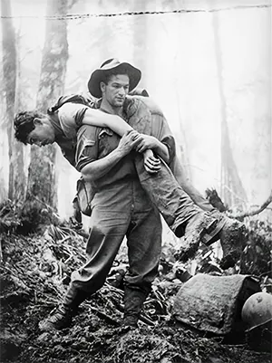 Australian soldier carrying his wounded mate to safety